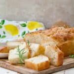 Fluffy focaccia with few smaller pieces on the board.