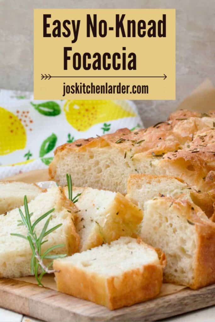 Fluffy focaccia with few smaller pieces on the board.