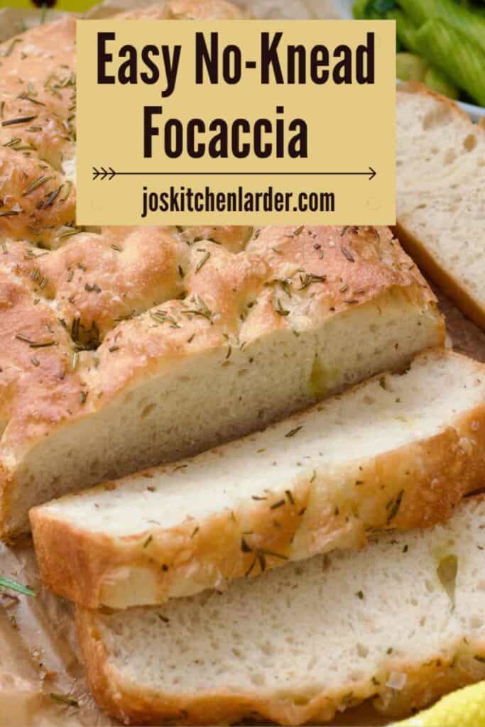 Focaccia with couple of slices cut in front of it.