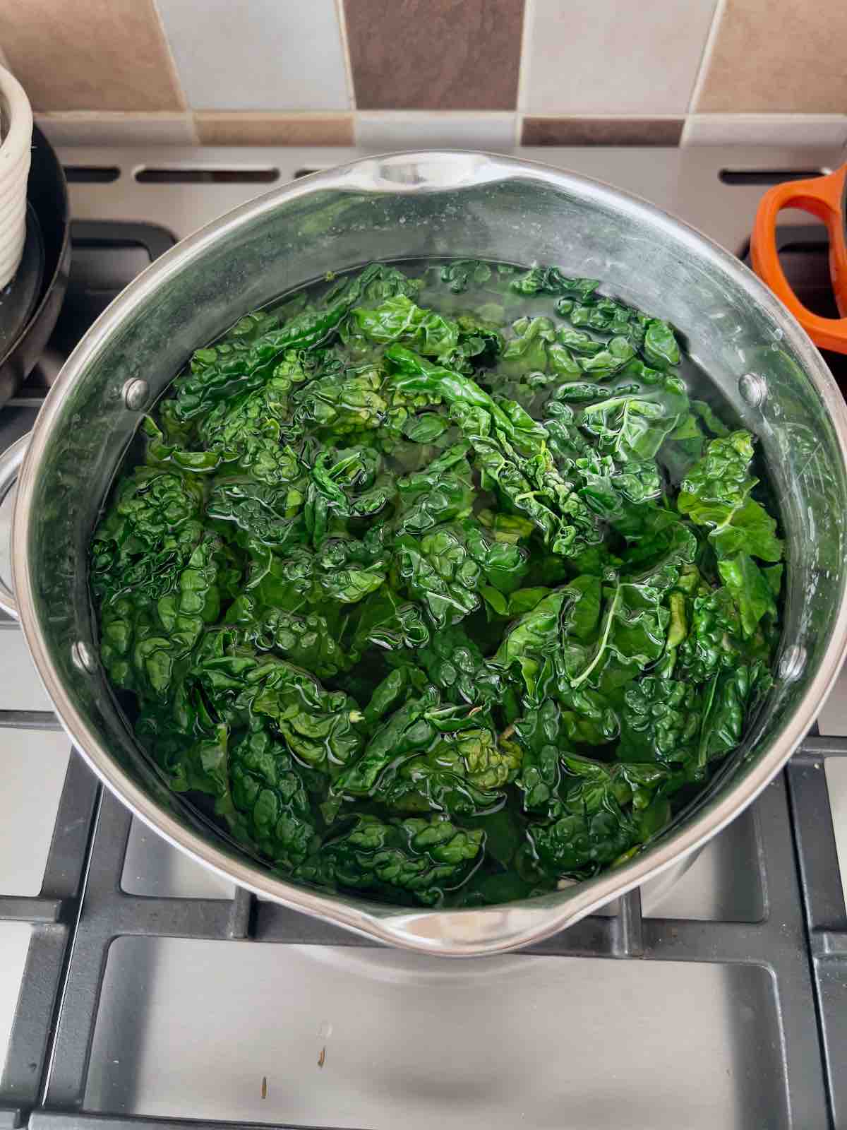 Cavolo nero being blanched in a pan.