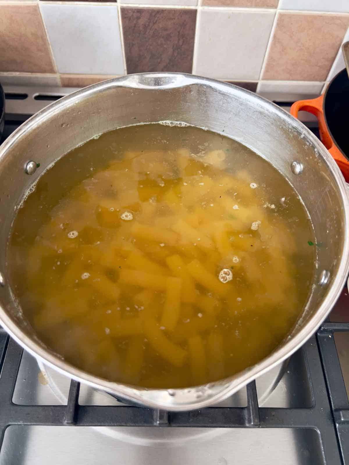 Pasta cooking in a pan.