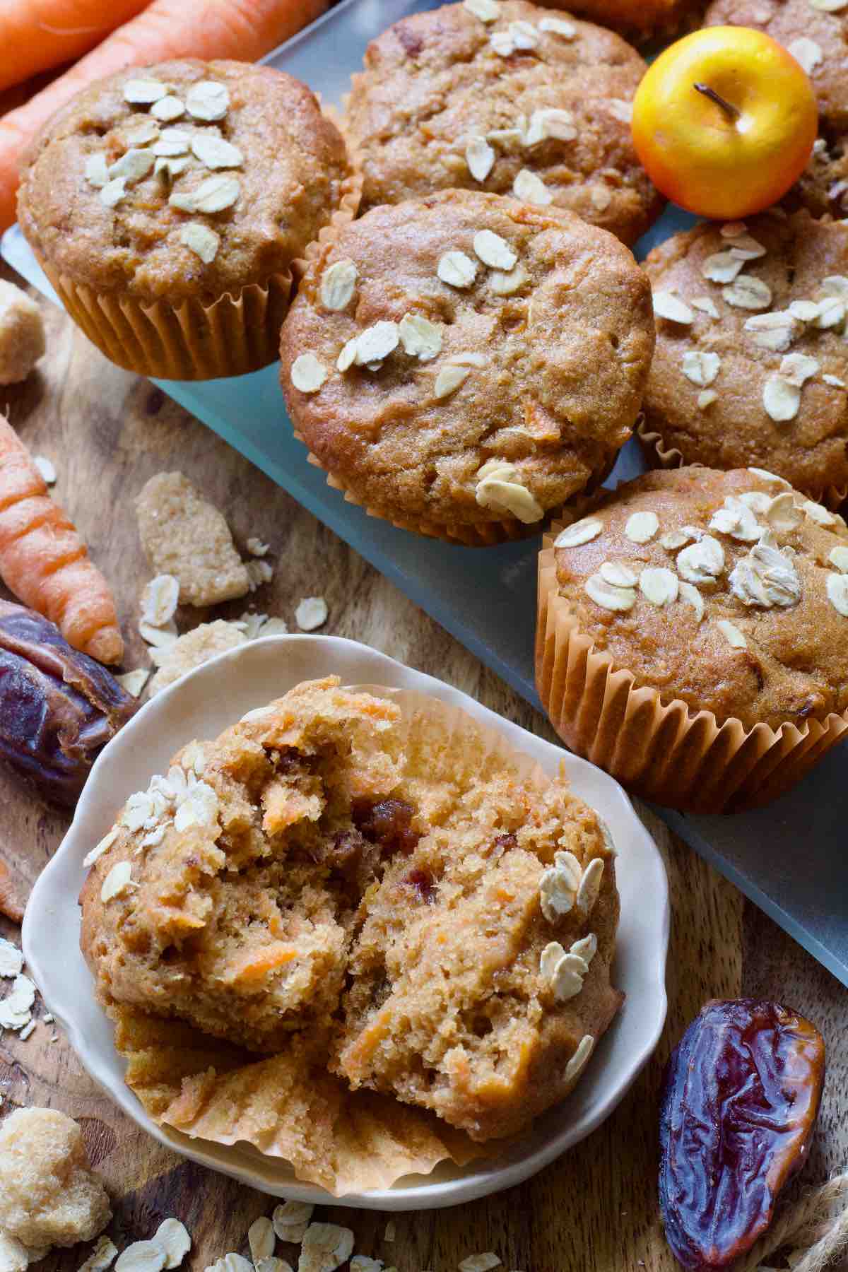 Close-up of carrot and date muffin in two pieces on a plate.