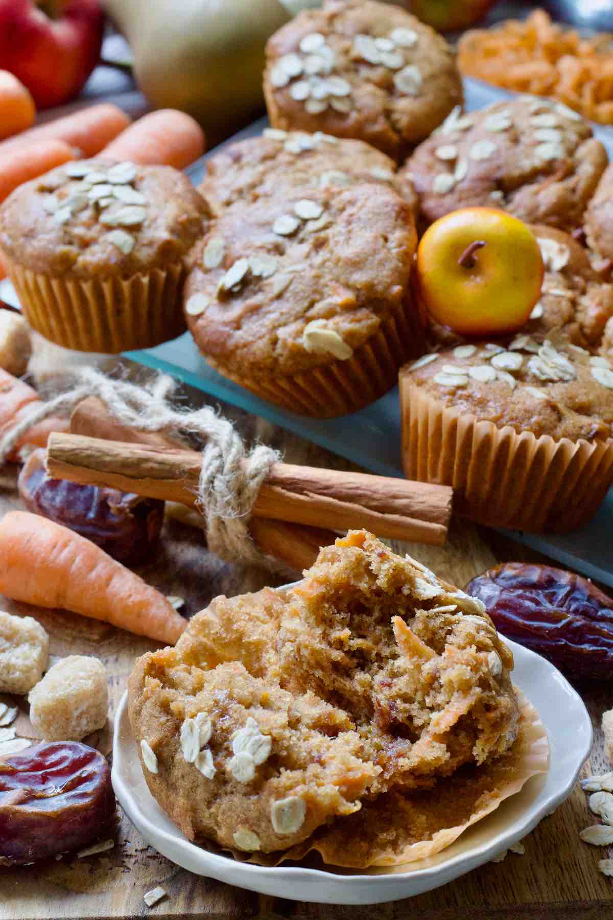 Opened up muffin on a plate with more muffins behind.