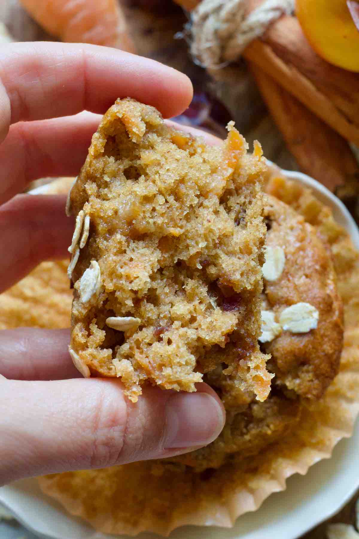 Hand holding half of a muffin.