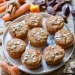 Close-up of 8 carrot and date muffins on a round plate.
