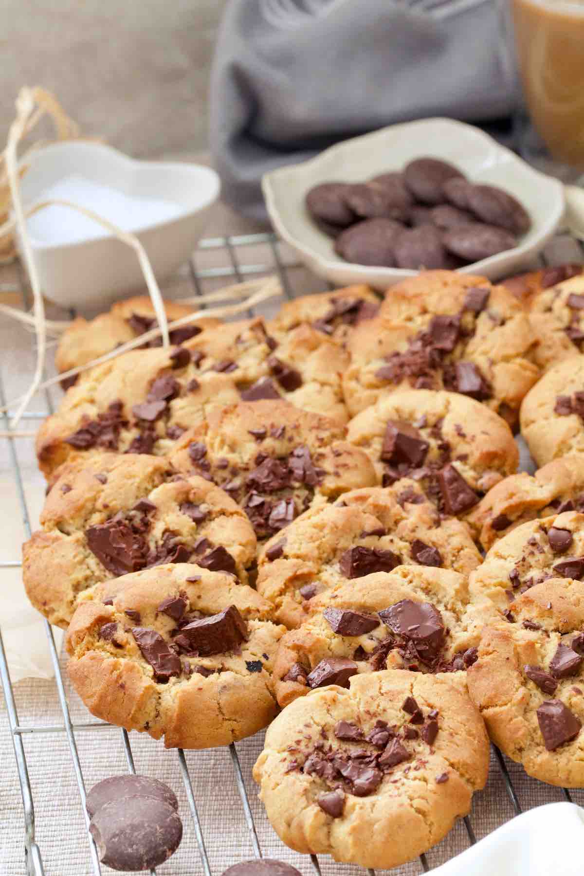 Chocolate chip cookies arranged on a cooling rack.