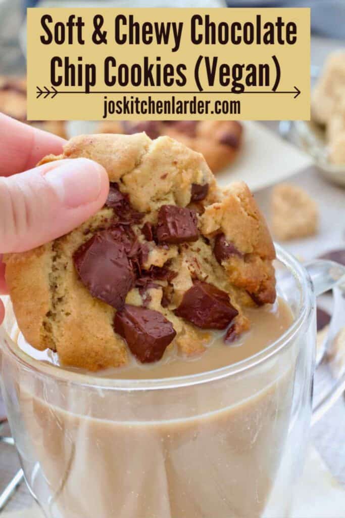 Hand dipping a cookie in a coffee.