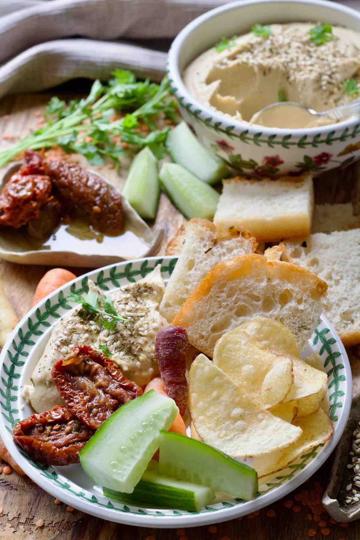 Small plate filled with red lentil hummus and other snacks.